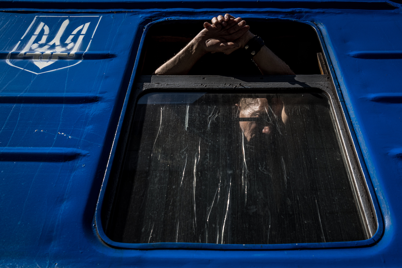 A man is seen leaning against an open window on board a west bound train leaving from Pokrovsk, Ukraine on August 5, 2022 Wolfgang Schwan - Anadolu Agency

As the fighting continued in Donbas and following the fall of Seiverdonetsk, civilians in the area were ordered by the administration to evacuate the region.